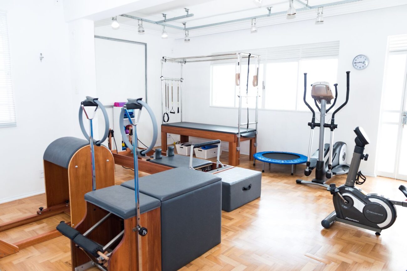 A home gym setup with various equipment in a bright room, illustrating a complete budget-friendly home gym