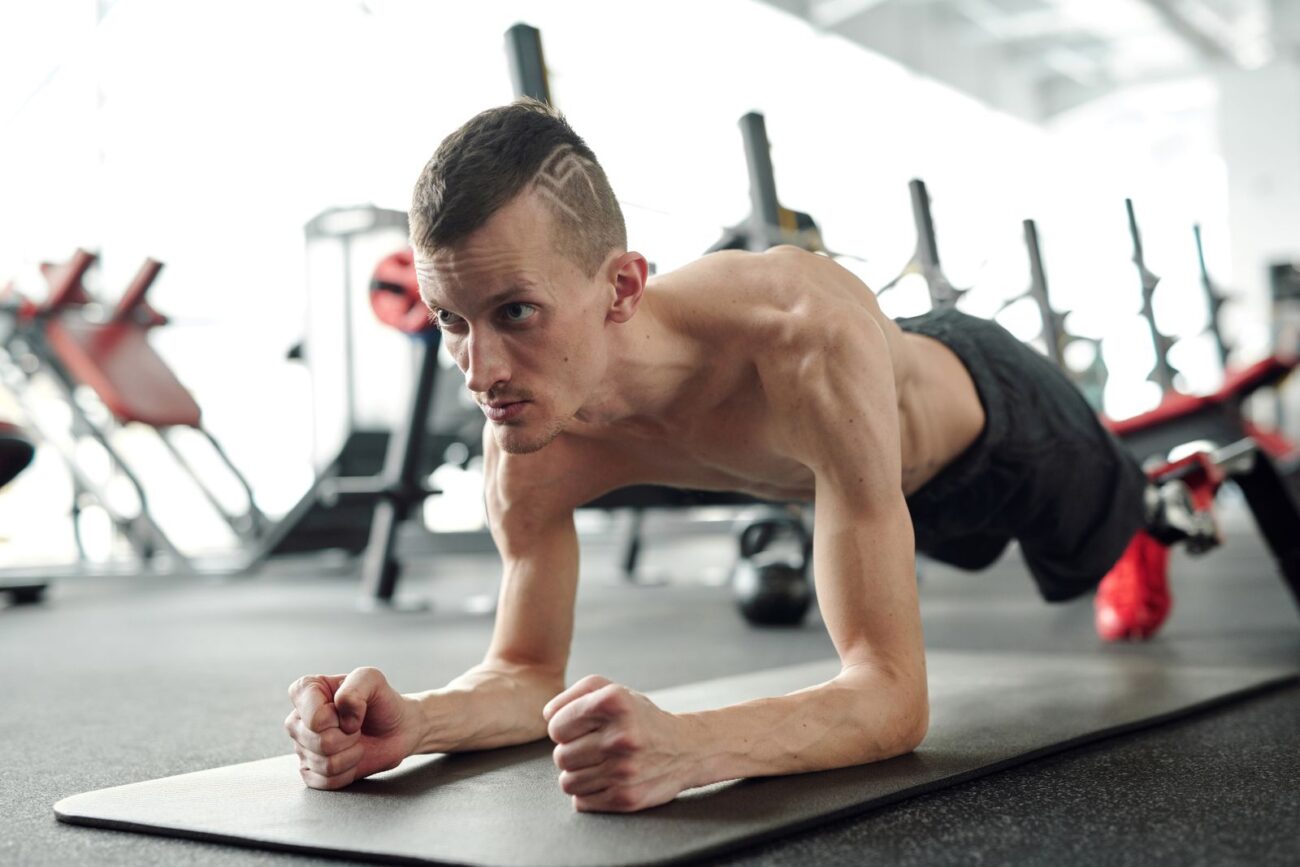 Man holding a plank to build core strength and stability