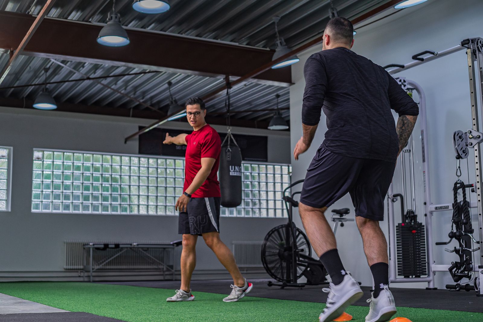 Two lifters doing a dynamic warm-up in the gym before training